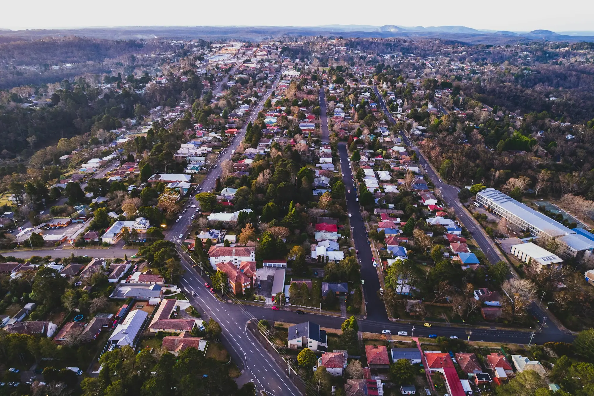 Aerial view of tree-lined suburban streets and family homes in an Australian city