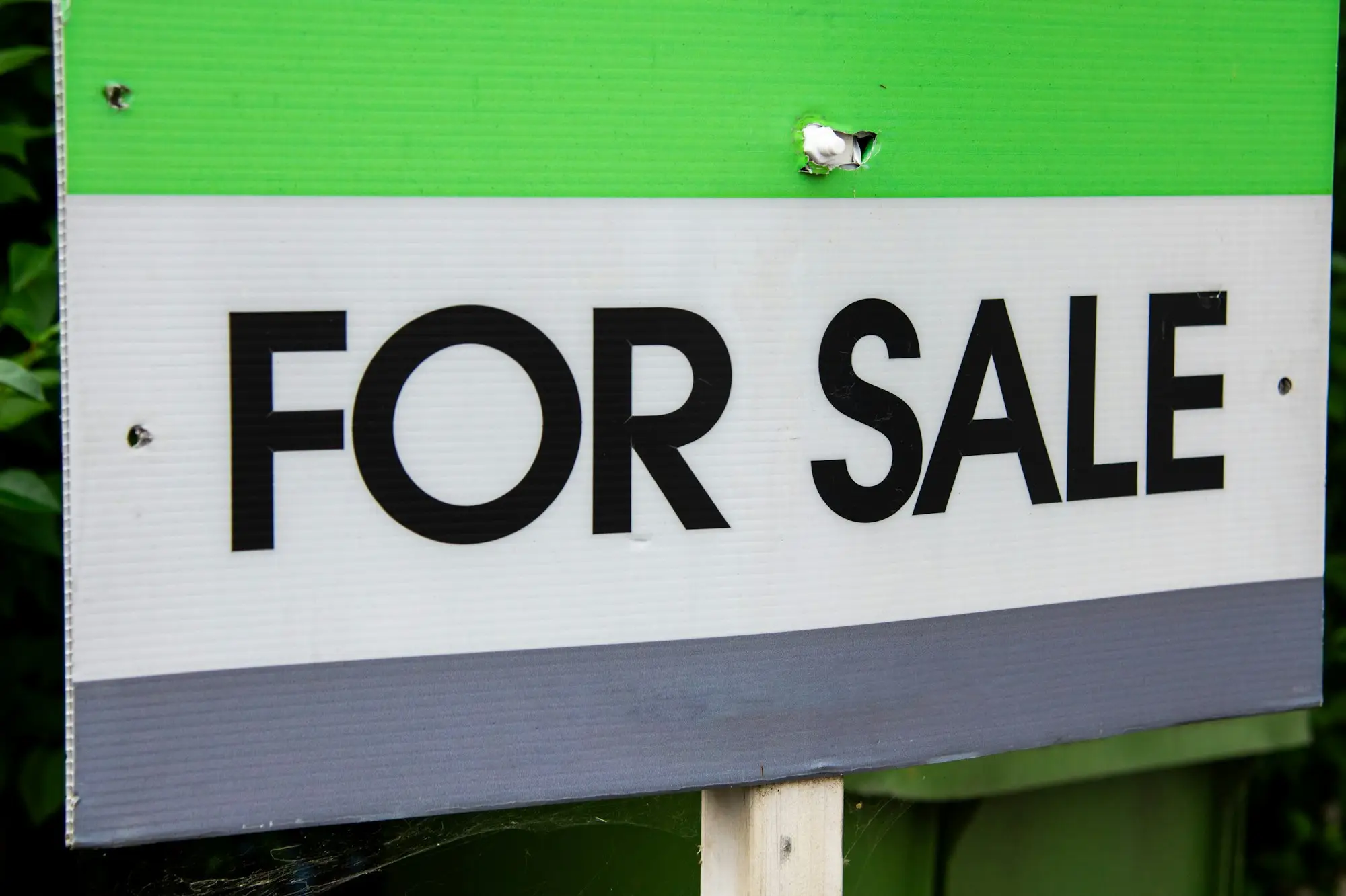 For sale sign outside a property that is being sold to repay a short-term loan