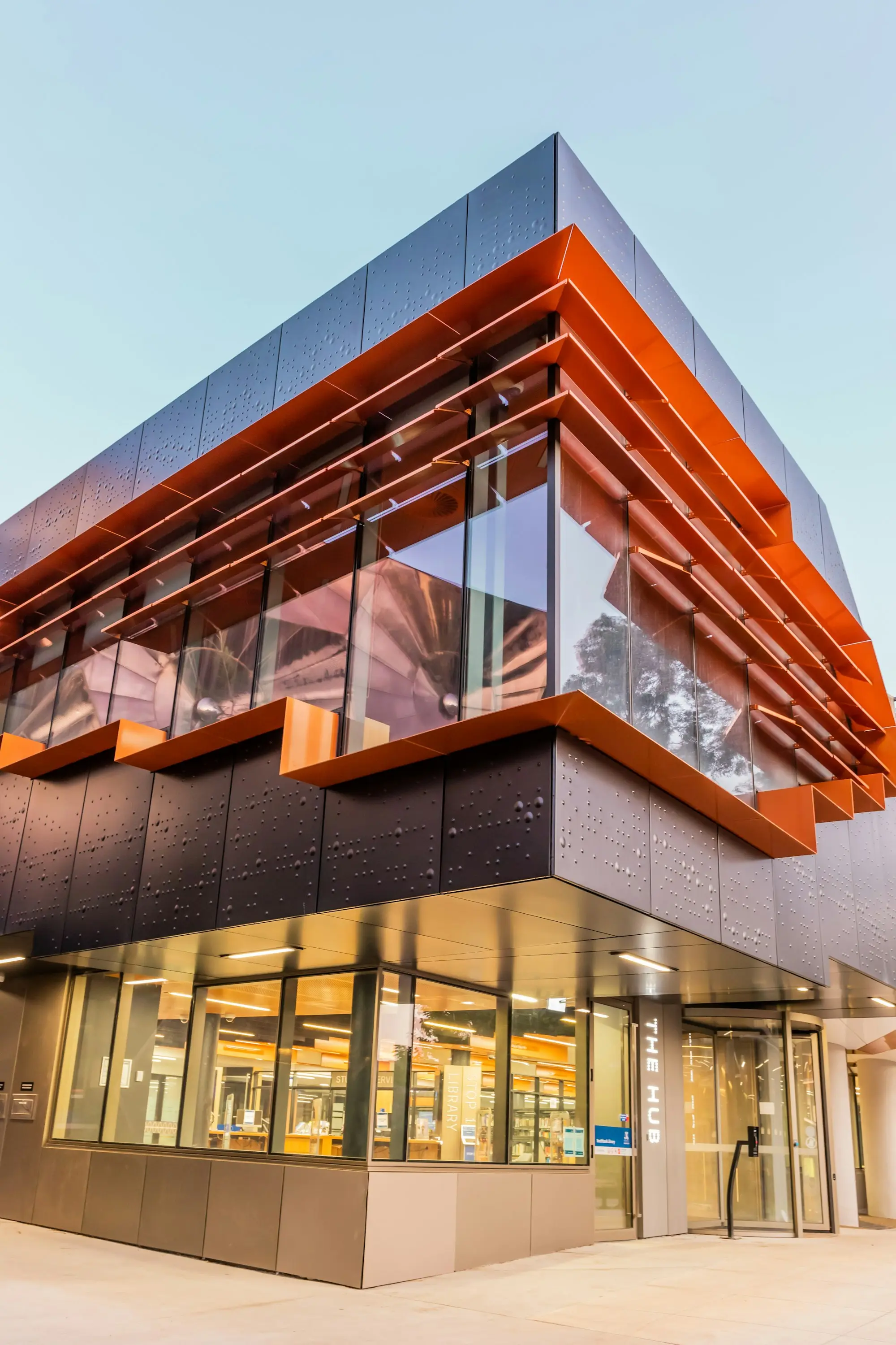 Modern commercial building with timber-look cladding that a business owner is buying as premises