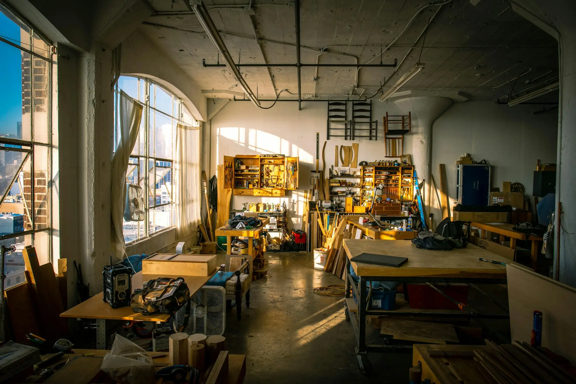 Busy timber workshop with benches and materials set up for a large incoming job