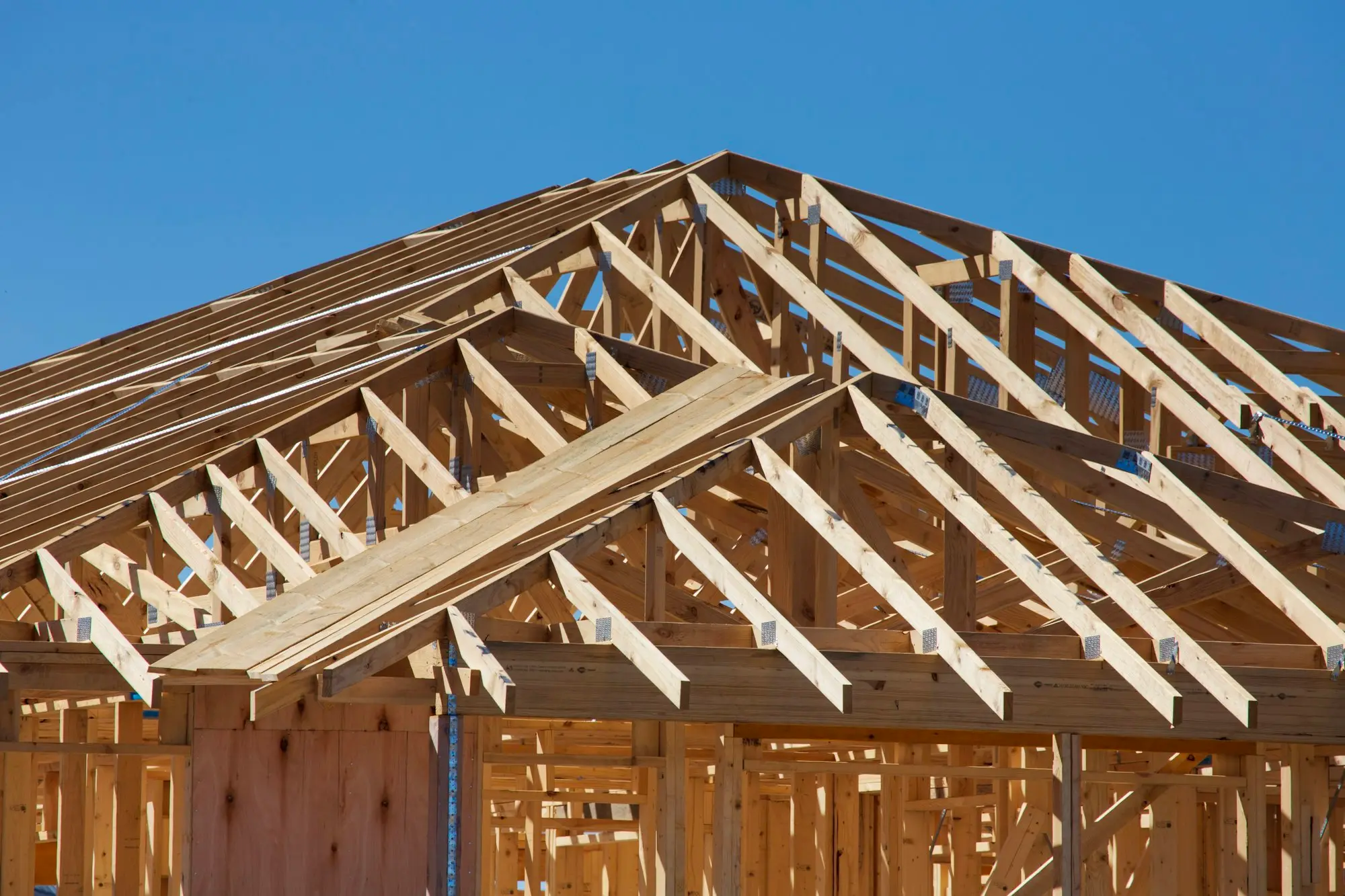 Timber roof and wall frames going up on a new house under construction