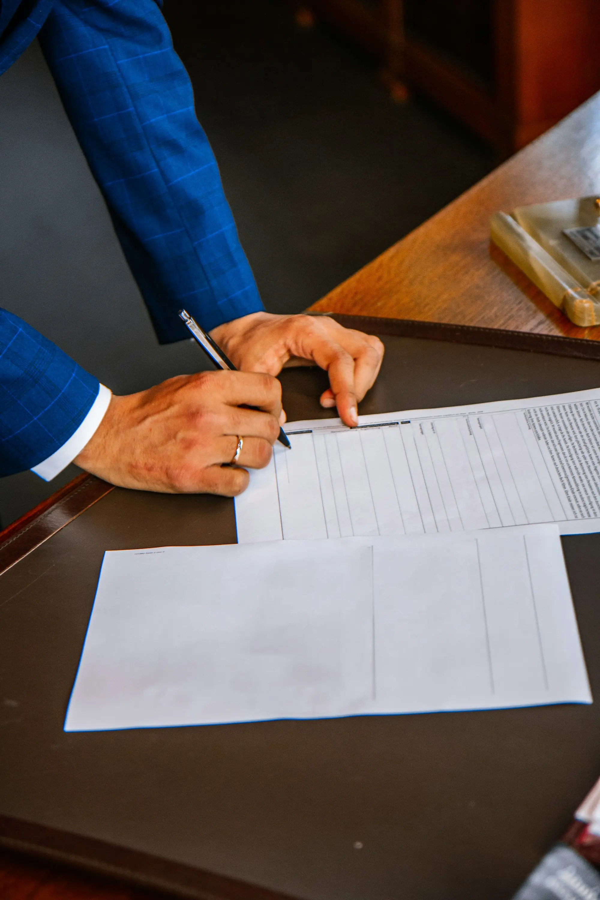 Settlement documents being completed and signed at a solicitor's desk